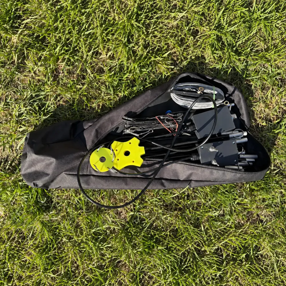 Ultra Light Cobweb Antenna packed in its transport bag with folded supports, coiled wires and mast mounts
